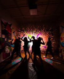 Witness a chaotic explosion of color and movement in this dynamic composition. Silhouetted figures are caught in the crossfir