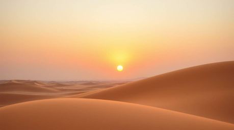 A breathtaking image showcasing a graceful and elegant sunset at the edge of a desert.  Soft pastel colors paint the sky, hig