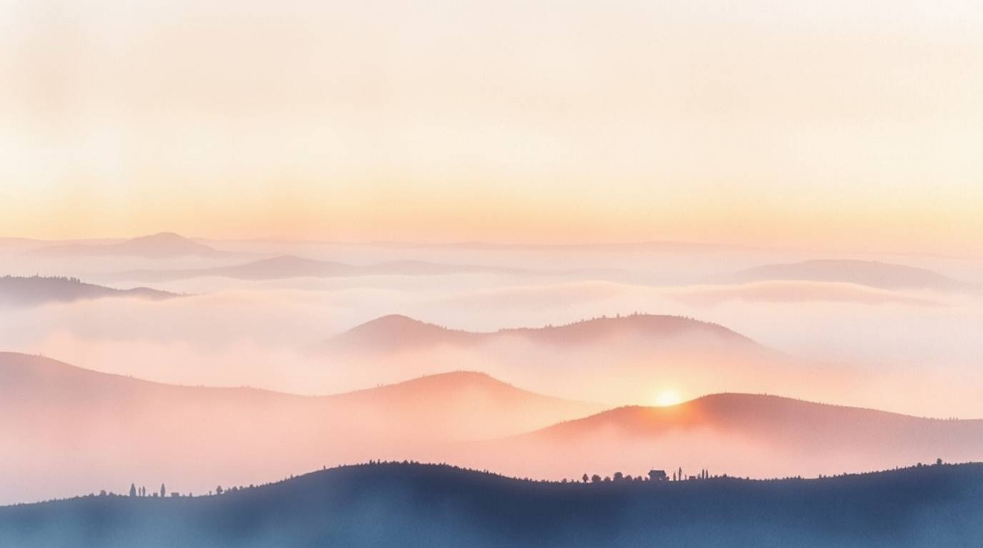 A delicate watercolor painting capturing the ethereal beauty of fog-covered hills at sunset. The artwork utilizes strong, har