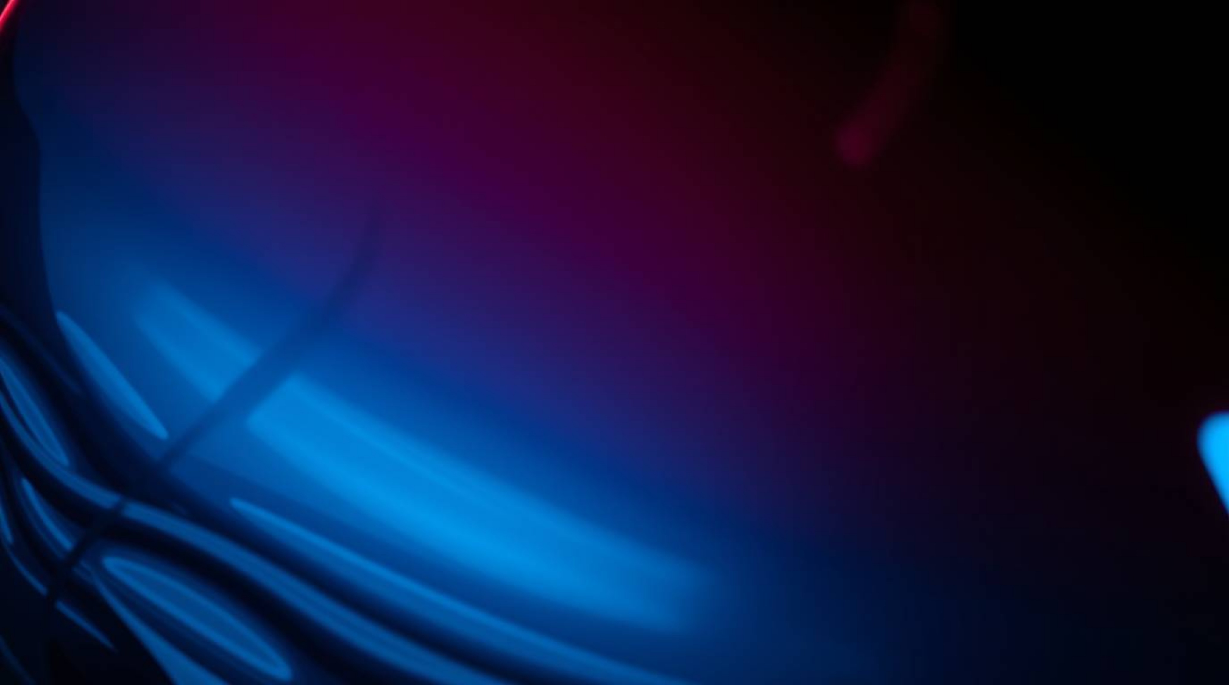 A captivating low-angle close-up showcases a glass object reflecting smooth gradient textures, bathed in rich burgundy and de