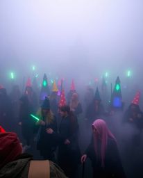 Discover a vibrant magical school shrouded in thick fog, where young wizards train amidst a captivating contrast of bright co