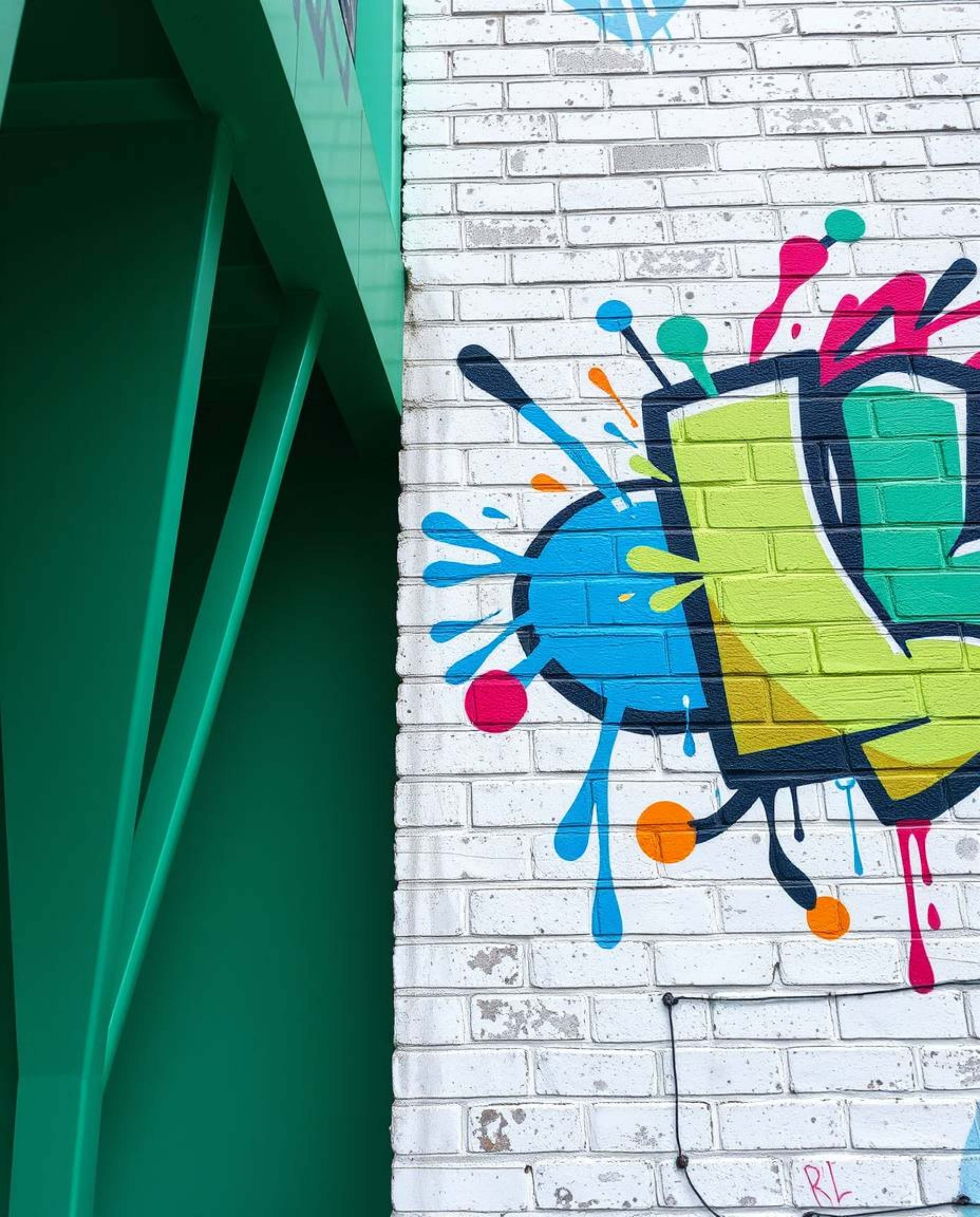 Capture the essence of urban art with precise architectural color photography showcasing graffiti-style colorful splashes on 