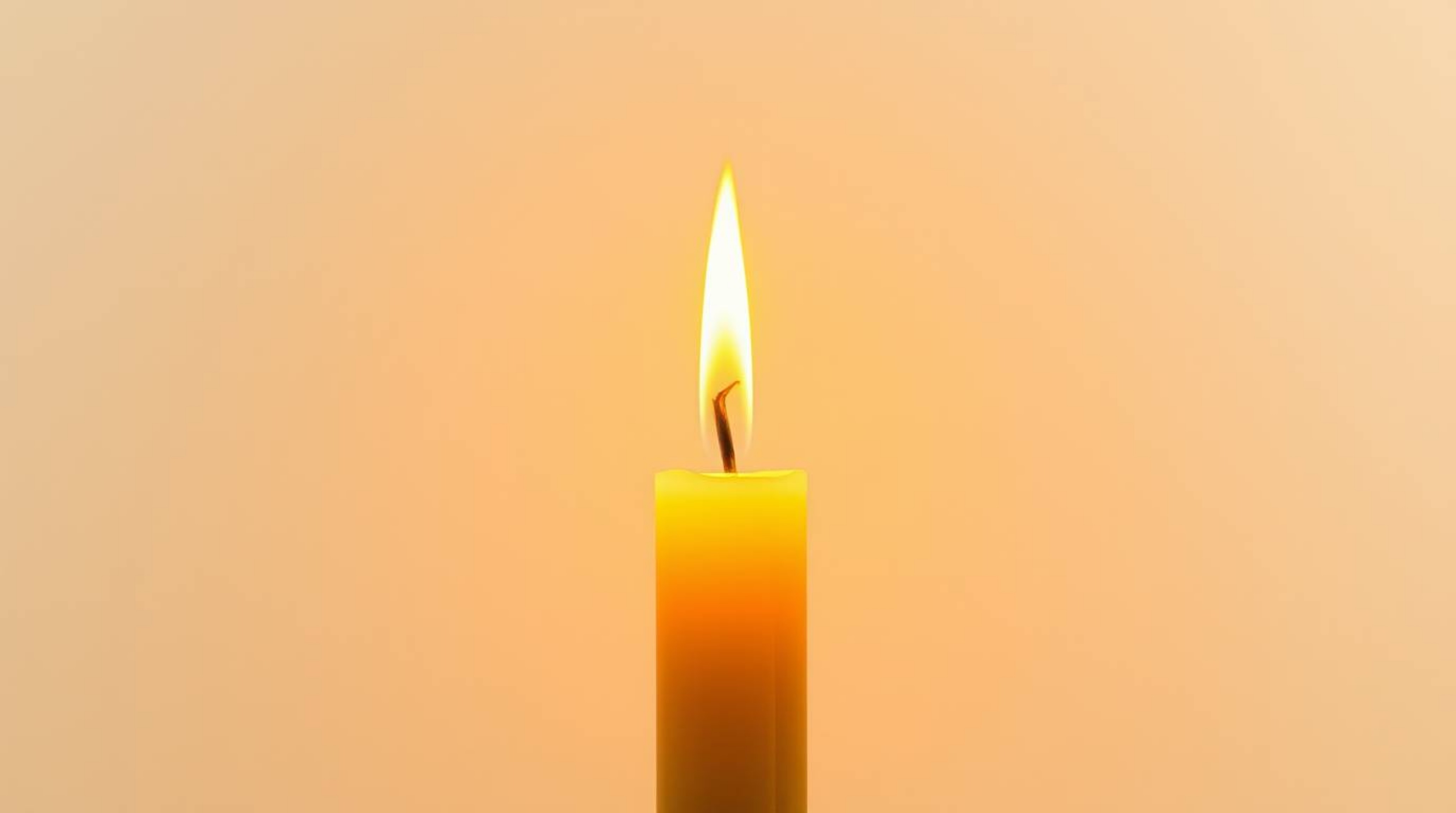Experience the serene beauty of warm candlelight illuminating an abstract gradient background, subtly enhanced with a delicat