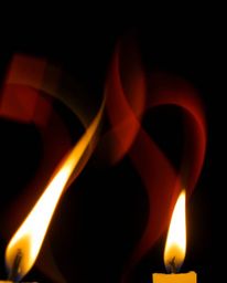 Capture the mesmerizing dance of candlelight with long exposure photography, showcasing dynamic and colorful splashes against