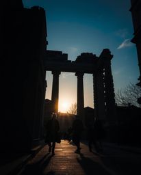 Experience ancient stone ruins within an urban scene, captured through the raw lens of candid street photography as a dramati
