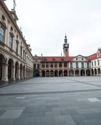 A captivating architectural photograph showcases an empty town square, emphasizing sharp lines and intricate details of the b