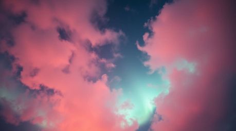 A breathtaking overhead shot captures the mesmerizing spectacle of the Northern Lights emerging over a vibrant sunset sky.  S