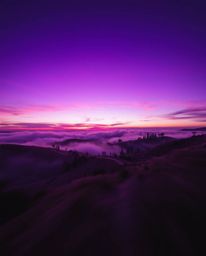 Dynamic motion deep ultraviolet hues depicting sunset over misty Tuscan hills, vivid purples, high contrast, blurred lines, a