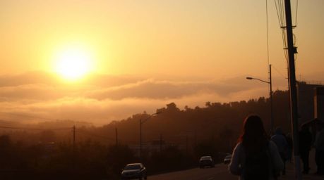 Capture the spontaneous beauty of a candid street photography image.  This breathtaking shot features fog-covered hills bathe