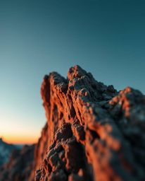 This is an extreme macro close-up, high-resolution stock photo of a sunset from a high alpine peak. It showcases a stunning b