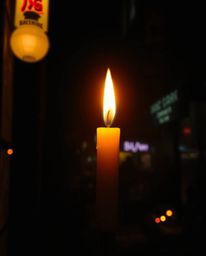 Immerse yourself in a moody cyberpunk aesthetic with warm candlelight contrasting against a pixelated glitch image of a neon-
