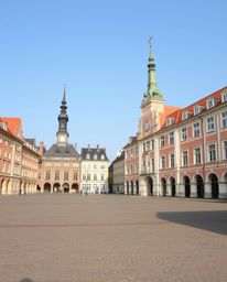 Explore stunning architectural color photography featuring an empty town square, characterized by sharp lines, detailed struc