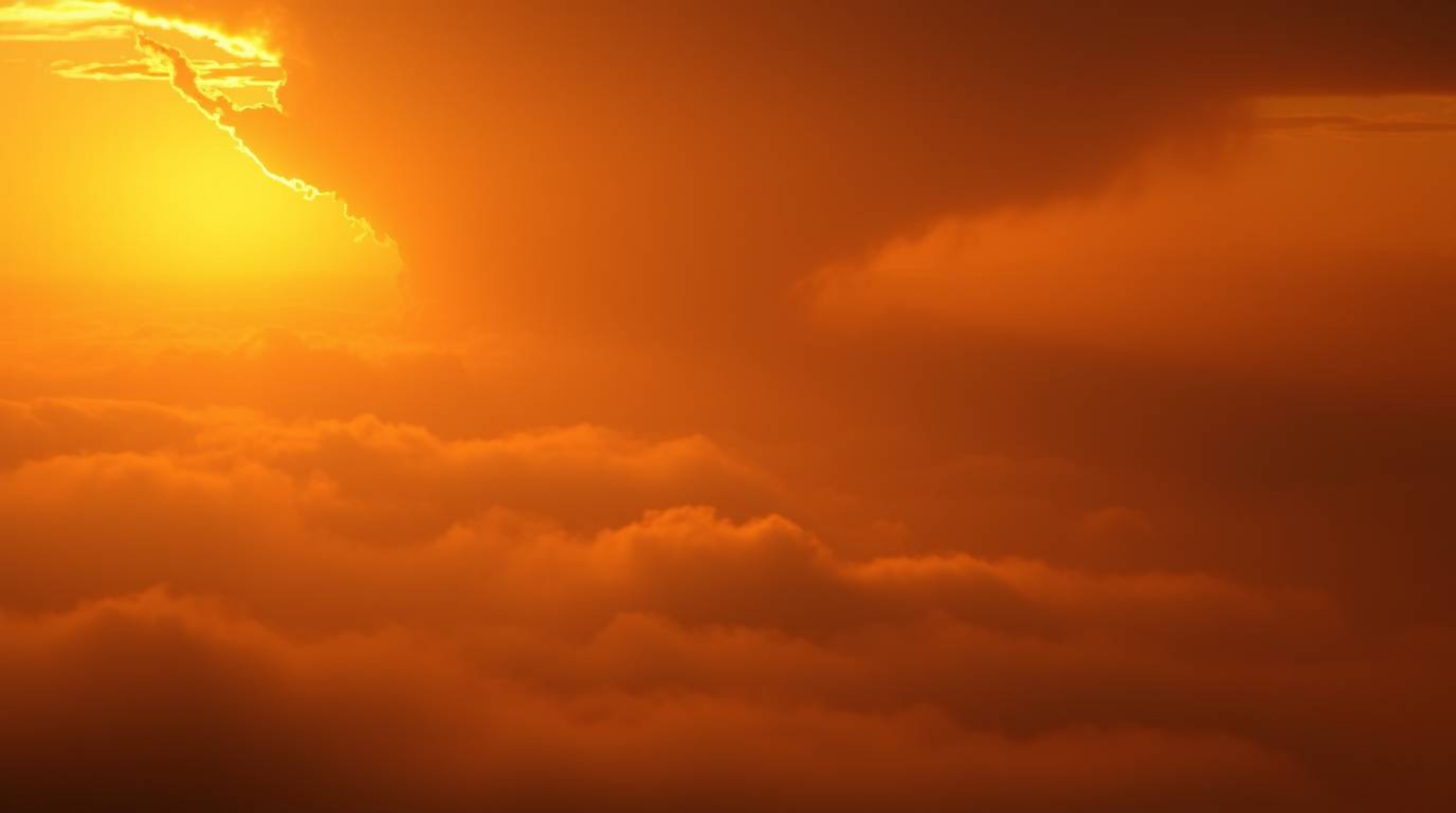 Experience the breathtaking beauty of a thunderstorm illuminated by the warm golden glow of a setting sun.  Thick fog creates