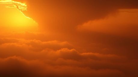 Experience the breathtaking beauty of a thunderstorm illuminated by the warm golden glow of a setting sun.  Thick fog creates