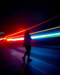 Experience the captivating beauty of long-exposure photography showcasing vibrant, electric light trails.  These images evoke