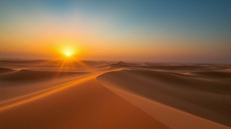 A breathtaking photograph capturing a mesmerizing sunset over golden desert dunes, enhanced by volumetric lighting that creat