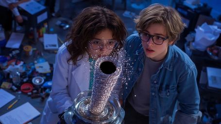 In a vibrant, high-contrast photograph with a Pixar-like aesthetic, a diverse teenage science duo, a young woman and a young 