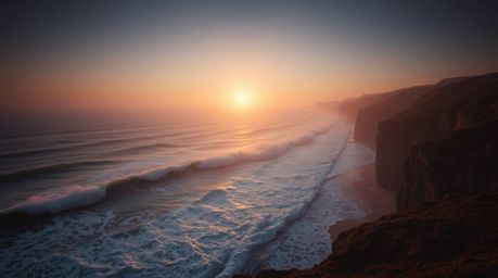 Experience the beauty of a high-angle perspective capturing waves crashing against cliffs beneath a fiery sunset. Volumetric 