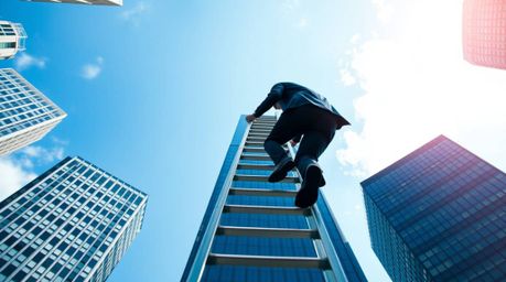 A captivating image depicting a businessperson ascending a transparent ladder that disappears into a vibrant blue sky above t