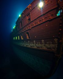 Discover stunning underwater shipwreck photography. This captivating image showcases a precisely captured, illuminated shipwr