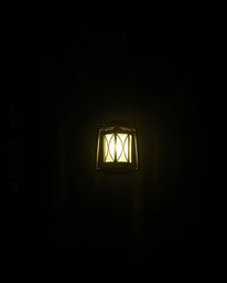 Experience the captivating interplay of light and shadow in this moody, creative light art photography. A glowing lantern ill