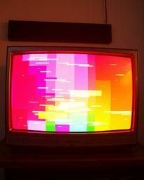 Experience a mesmerizing visual journey with a TV screen displaying radiant and luxurious RGB separated glitch static in a re