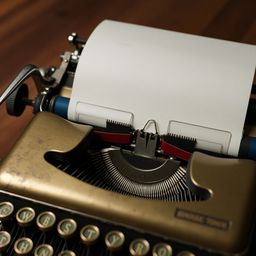 A stunning close-up image showcasing a vintage mechanical typewriter's intricate details.  From its worn, golden metal body a