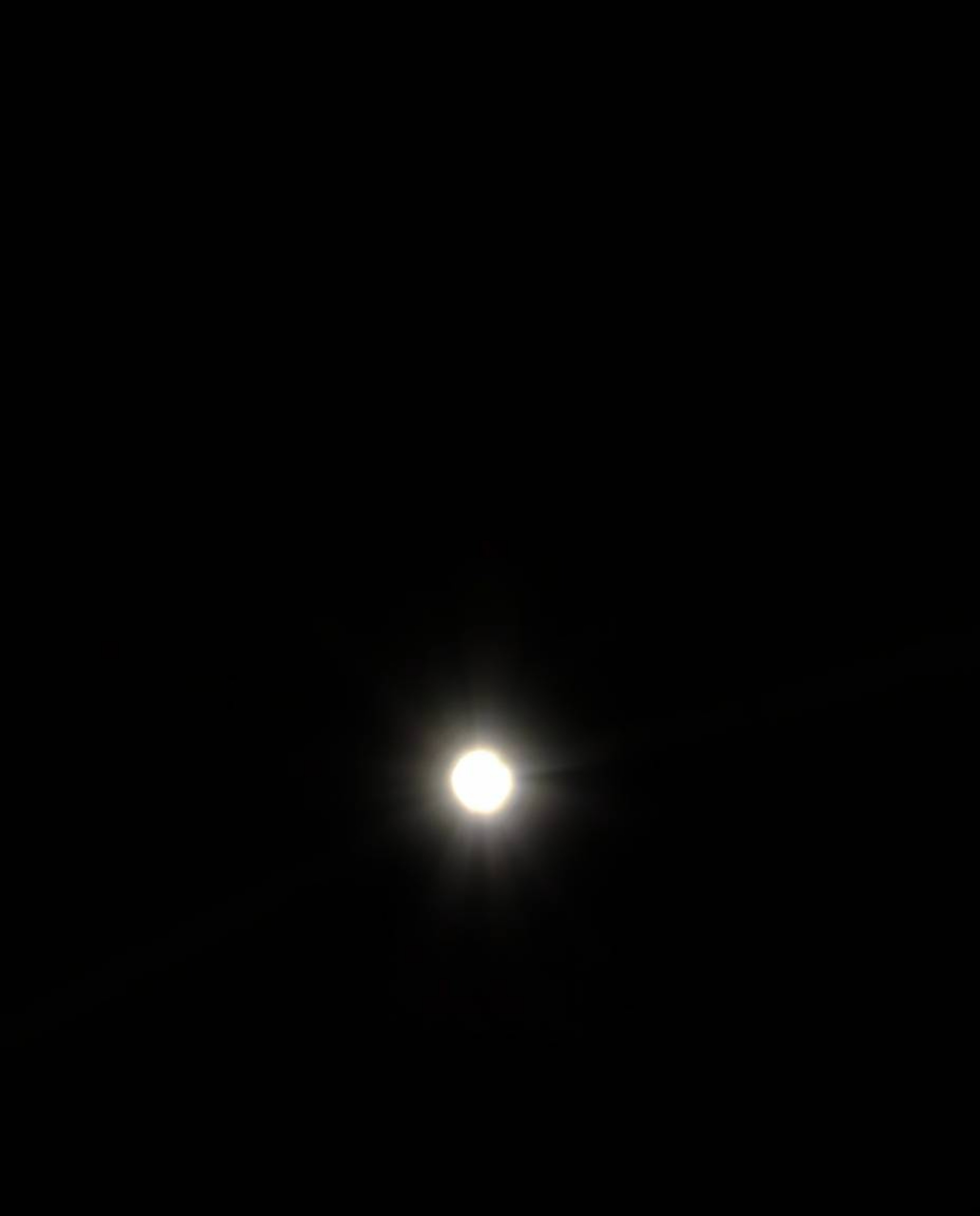 Captured from a dramatic low-angle perspective with high contrast and low-key lighting, this image features eyes watching int