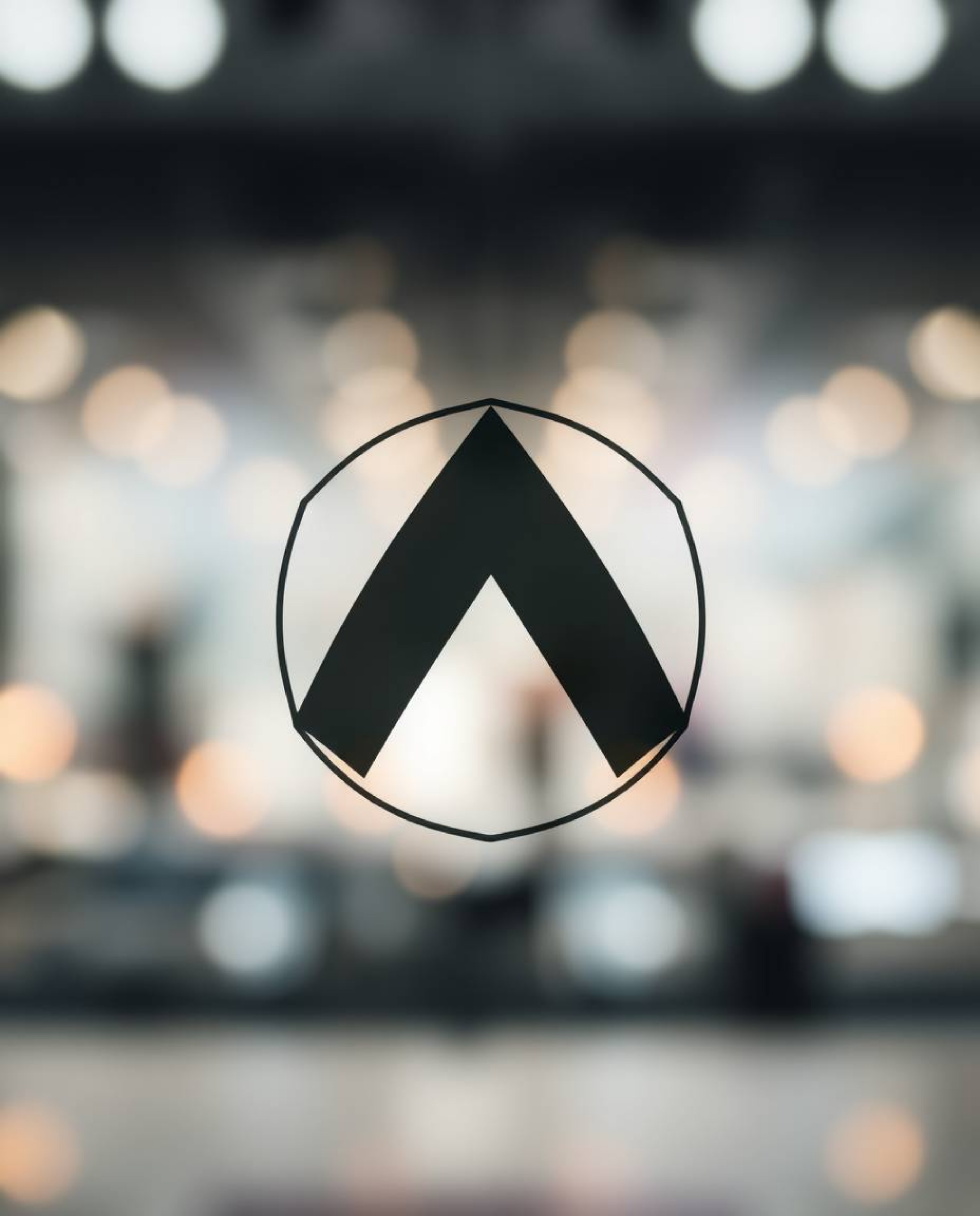Explore mesmerizing visuals with a high contrast logo featuring a blurred bokeh effect and sharp subject focus, accentuated b