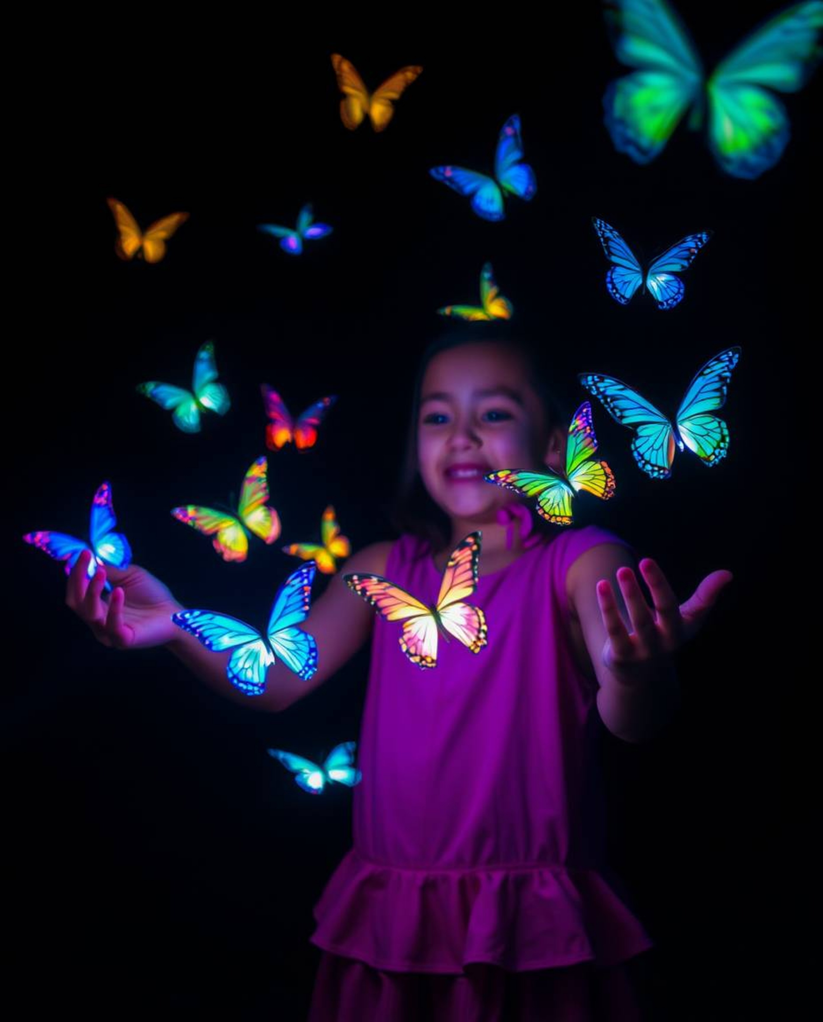 A captivating long exposure photograph showcases a girl releasing bioluminescent butterflies into the night sky.  Their glowi