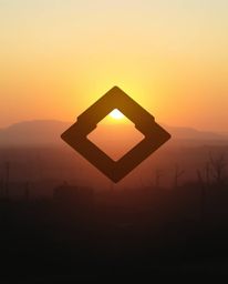 A captivating image depicting a soft, dreamy sunrise over a war-torn landscape.  The scene is enhanced by a geometric logo-in