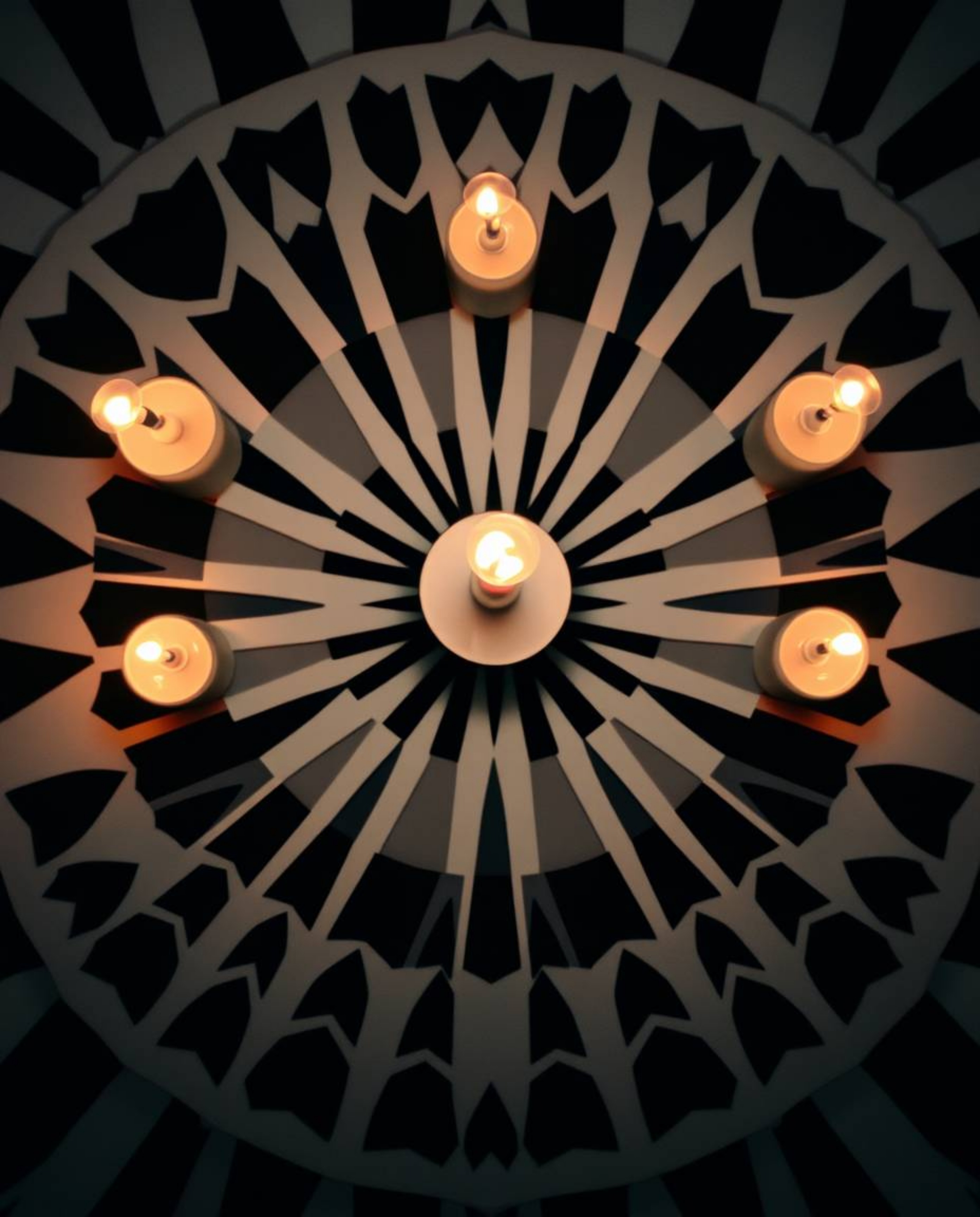 A captivating retro-style black and white geometric optical illusion pattern comes to life, illuminated by the warm and flick