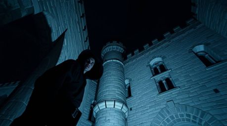 A high-angle architectural photograph depicts a thief, clad in dark clothing with a subtly shadowed face, sneaking into a med