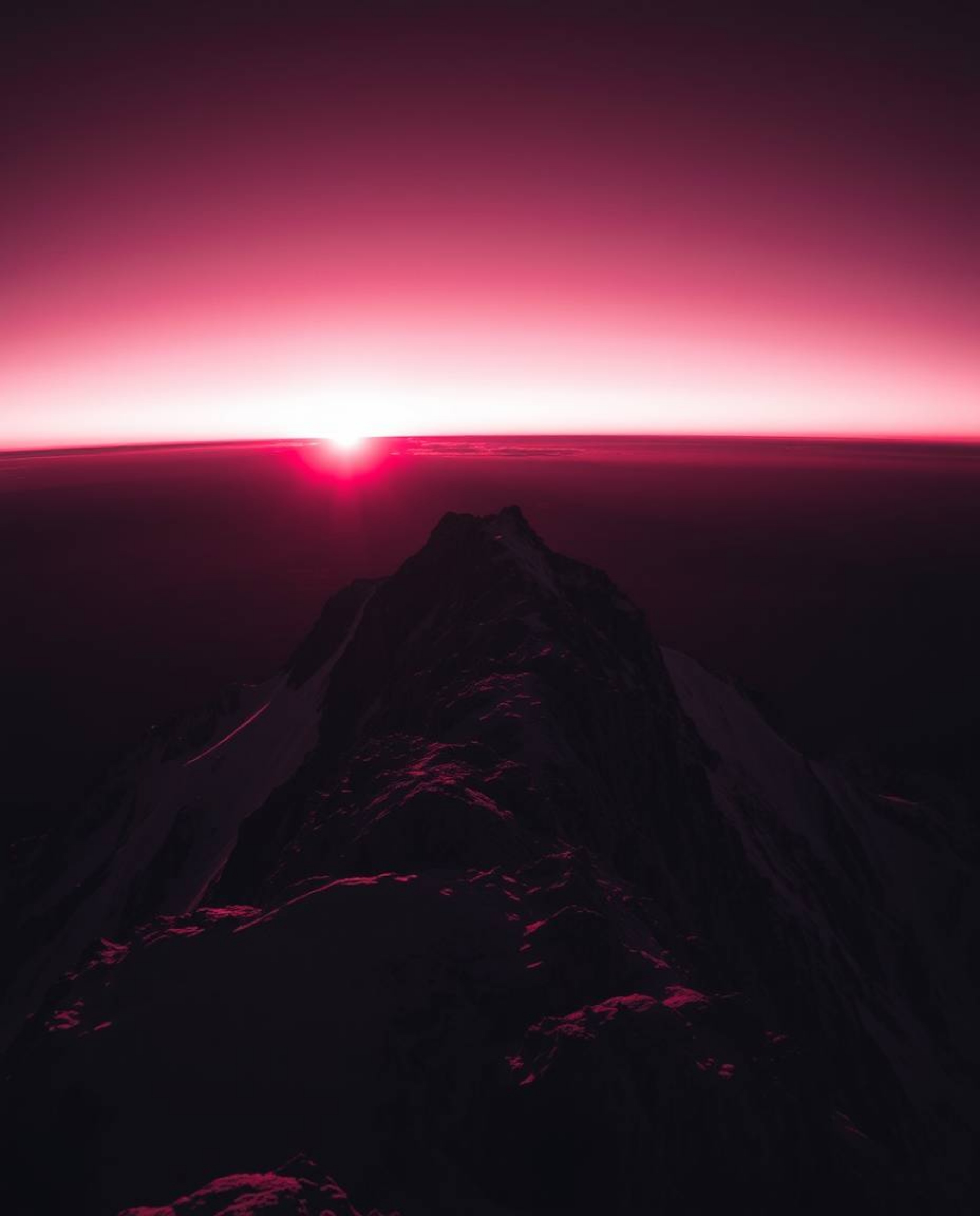 Experience a surreal and dramatic vision of a sunset from a high alpine peak with this high-contrast, low-key image. Rendered
