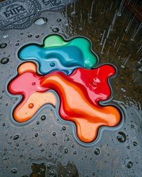 A captivating high-angle perspective showcasing a wet, rainy scene where vibrant, 3D fluid shapes playfully interact with str