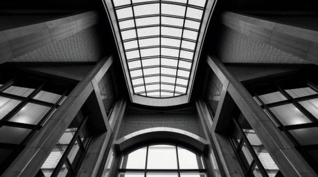 This striking image showcases a classic black and white architectural photograph infused with a gradient mesh pattern.  The s