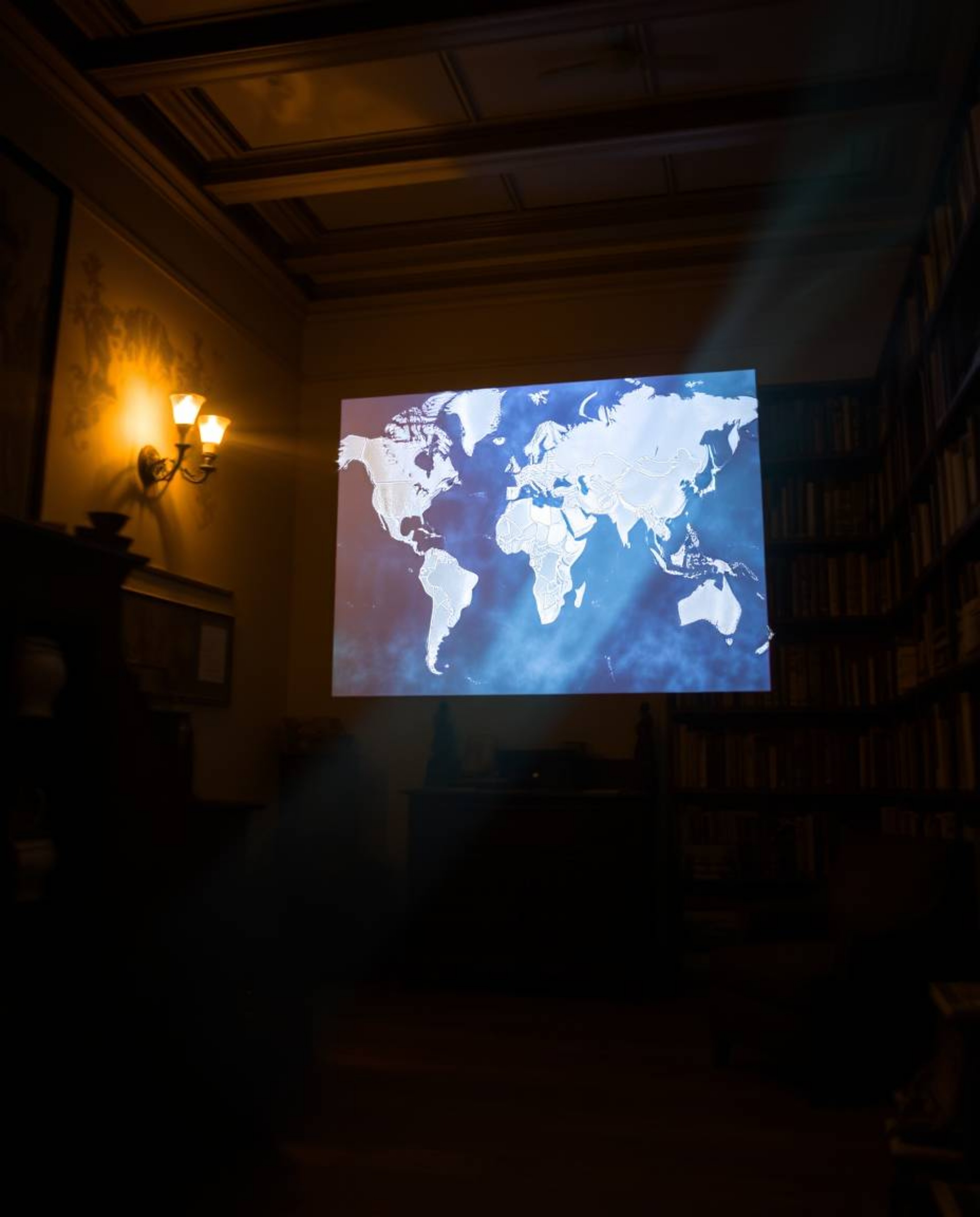 Capture the ethereal beauty of a glowing map projection in an old study with this long exposure photograph. The image feature