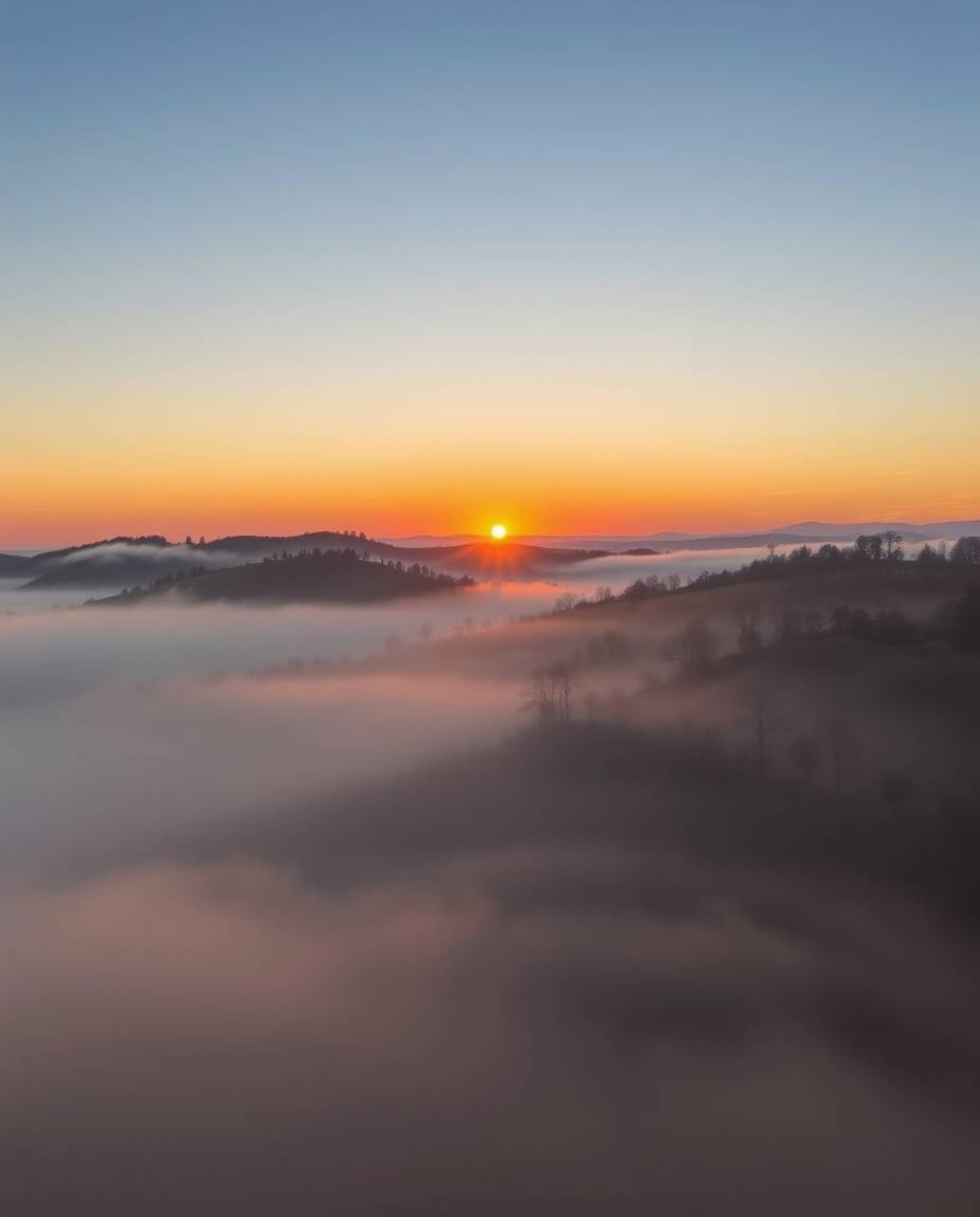 Sunset over misty rolling hills in Tuscany: low visibility, thick fog, thick foggy surroundings.