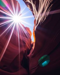 This image captures sandstone cliffs illuminated by a brilliant sunset in a canyon, viewed from a striking low-angle perspect