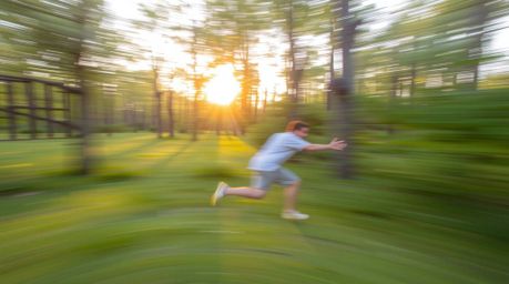 A captivating scene showcasing dynamic motion captured with soft pastel colors in a golden hour forest. Blurred lines depict 