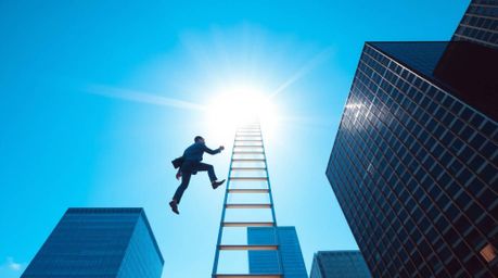 An ambitious businessman ascends a transparent ladder reaching towards a vibrant blue sky above towering skyscrapers. This ab