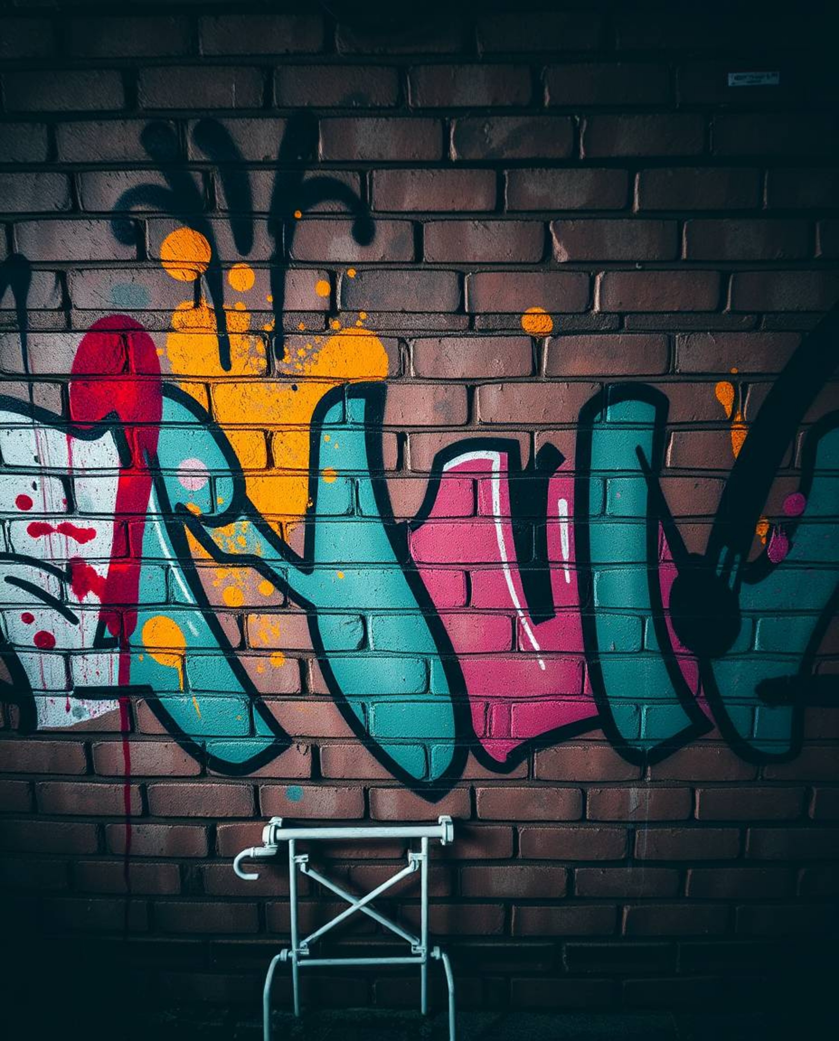 A captivating professional fine art photograph showcases vibrant graffiti-style splashes on a textured brick wall.  The image