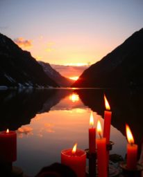 An image of a glassy fjord reflecting a sunset, characterized by bright, vibrant colors and a lively and energetic atmosphere