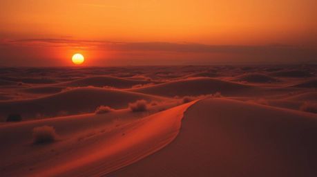 Experience a surreal infrared-toned image of a sunset at the edge of a desert.  Golden dunes are bathed in high-contrast, low