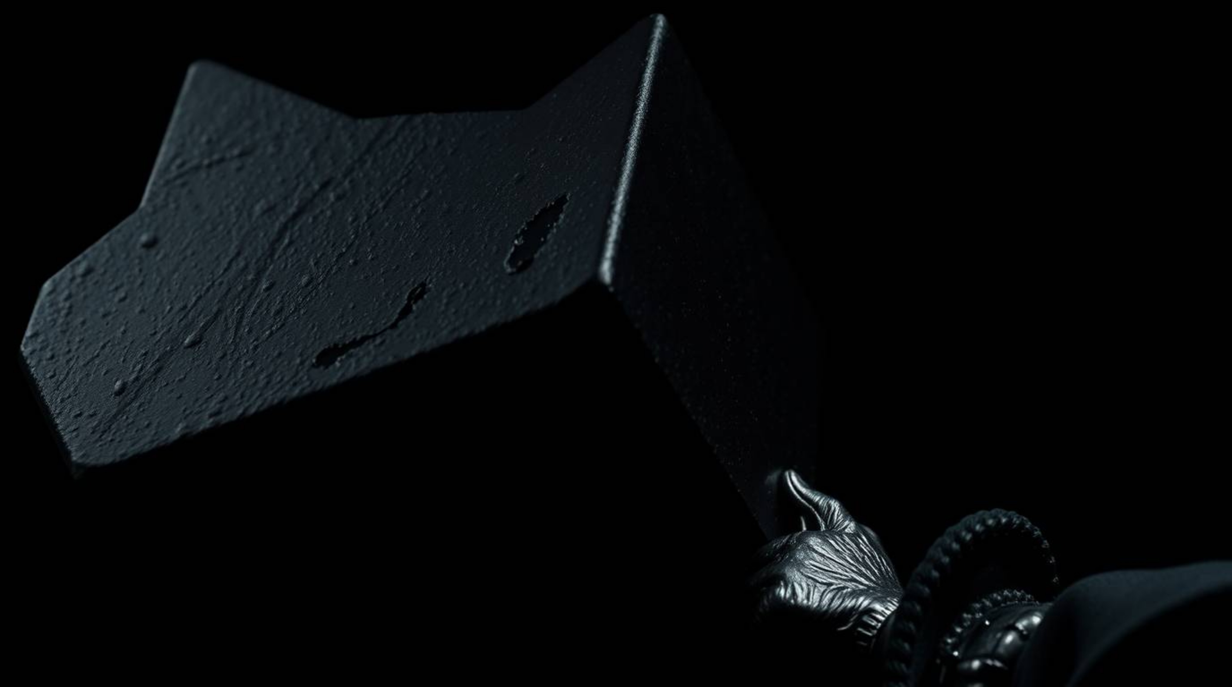 A striking, intensely detailed, jet-black close-up image showcasing an anvil poised to crush a trickster character. The pure 
