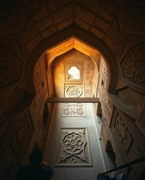 Explore the beauty of Islamic geometric patterns meticulously carved in stone, captured through a high-angle perspective in t