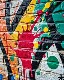 A captivating close-up showcases vibrant, graffiti-style splashes on a brick wall, reminiscent of Isekai anime.  The detailed