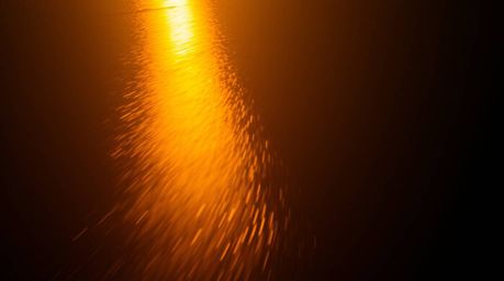 A captivating long-exposure photograph showcases a river delta bathed in warm, golden light.  The image captures the radiant 