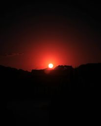 A dramatic cinematic-style image of a sunset over a serene Zen garden, rendered in intense jet black with deep shadows and fi