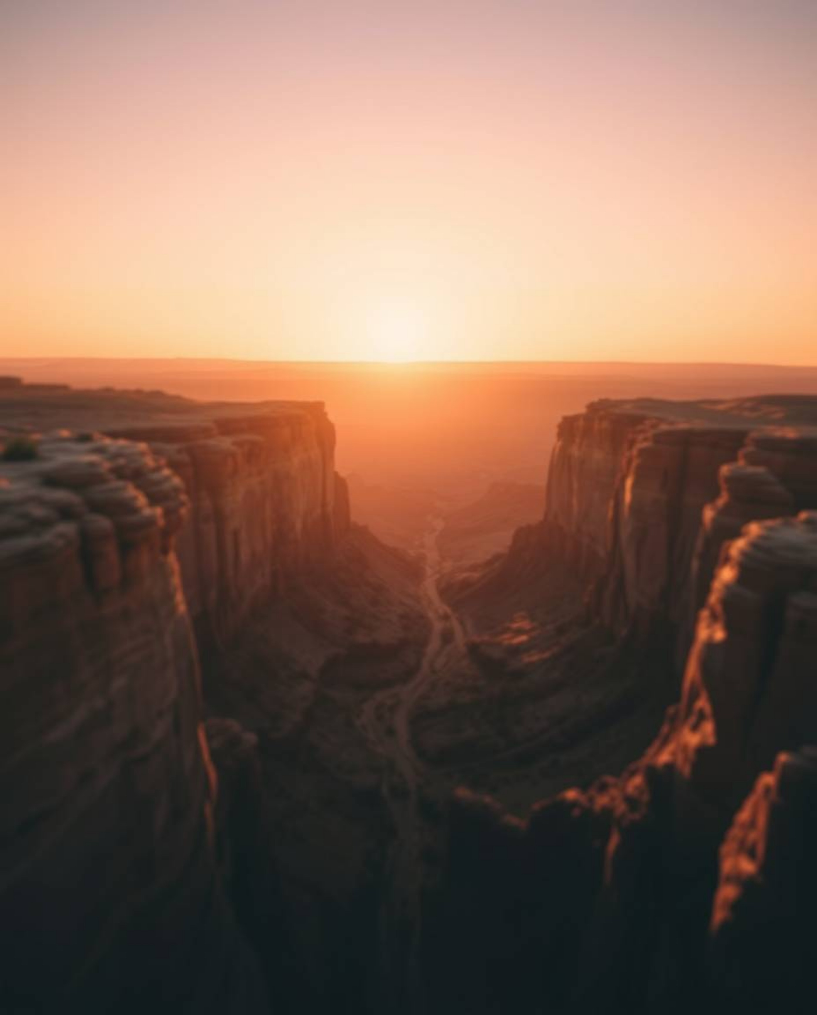This artwork presents an overhead, bird's-eye view of a sunset illuminating a canyon's sandstone cliffs, all rendered in a be